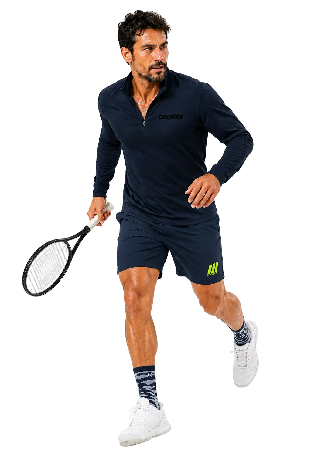 A man in athletic wear, including a navy long-sleeve quarter-zip top and matching navy shorts with a bright green logo, is captured mid-stride while holding a tennis racket against a solid white background.
